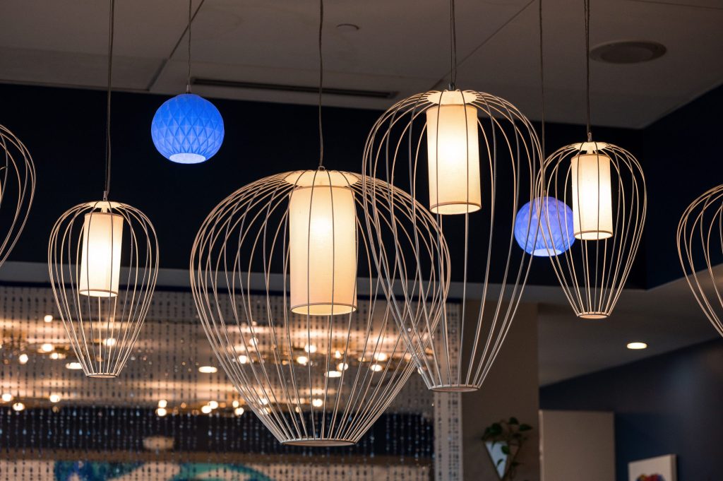 Wire pendant lights and blue glass globes above the Gather dining room