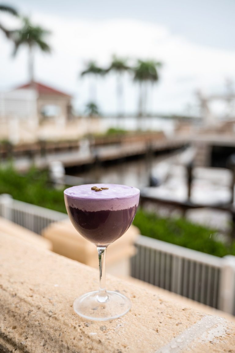 Purple cocktail overlooking the marina at Gather.