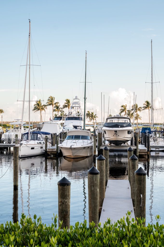 Sailboats and motor boats moored at the docks at Tarpon Point Marina.